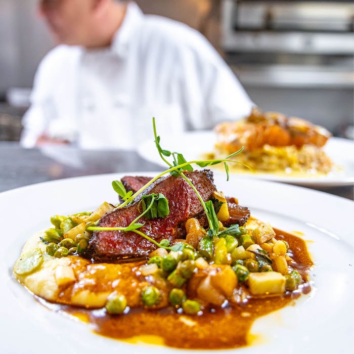 Chef James Africano serves Roasted Spring Lamb Sirloin at The Warehouse, part of the spring 2026 seasonal menu.