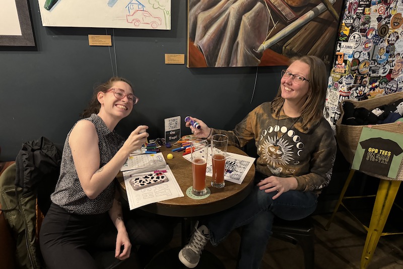 Two women play bingo at Goat Patch Brewing in Colorado Springs.
