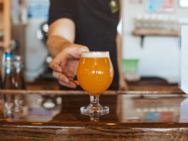 The State of Craft Beer in Colorado Springs Goat Patch bartender serving a craft beer in Colorado Springs.
