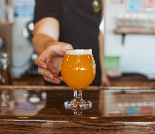 The State of Craft Beer in Colorado Springs Goat Patch bartender serving a craft beer in Colorado Springs.