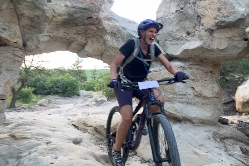 A woman mountain biking in Colorado Springs with WMBA.
