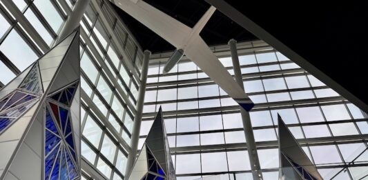 Inside the New Air Force Academy Visitor Center Inside the glass atrium at the U.S. Air Force Academy Visitor Center with stained glass tetrahedrons and a glider suspended overhead.