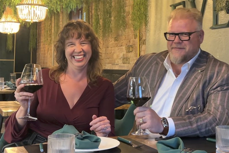 Lauren Ciborowski and Benjamin Harvey, longtime CC Summer Music Festival concertgoers and supporters raise a wine toast at Evergreen restaurant.