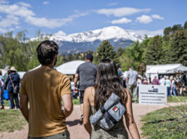 5 Best Things to Do in Colorado Springs This Weekend A couple walks toward the tents at the Garden of the Gods Art Festival with Pikes Peak in the background.