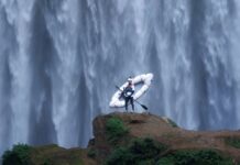 5 Best Things to Do in Colorado Springs This Weekend A kayaker stands in front of a massive waterfall in an image for the Paddling Film Festival, one of the best things to do in Colorado Springs this weekend.