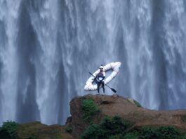 5 Best Things to Do in Colorado Springs This Weekend A kayaker stands in front of a massive waterfall in an image for the Paddling Film Festival, one of the best things to do in Colorado Springs this weekend.
