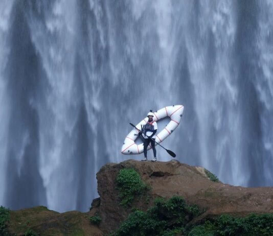 5 Best Things to Do in Colorado Springs This Weekend A kayaker stands in front of a massive waterfall in an image for the Paddling Film Festival, one of the best things to do in Colorado Springs this weekend.