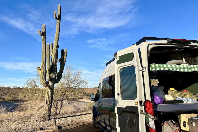 Adventure Wagon and saguaro cactus at Lake Pleasant Regional Park on a van life road trip to Sedona