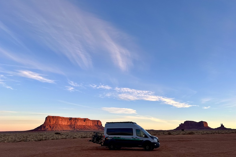 Monument Valley begins to glow at dawn on our Adventure Wagon van life road trip to Sedona.