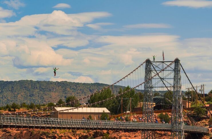 An athlete highlining over the Royal Gorge Bridge.