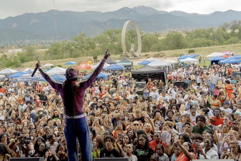 Backstage view of a singer on stage at the Juneteenth Festival in Colorado Springs