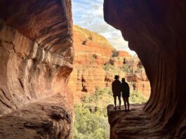 Testing the Van Life on a Red-Rock Road Trip Two hikers silhouetted in the sun at Subway Cave in Sedona, Arizona.