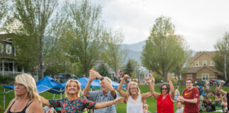 Neighbors dance in a line at Music on the Mesa at Gold Hill Mesa in Colorado Springs