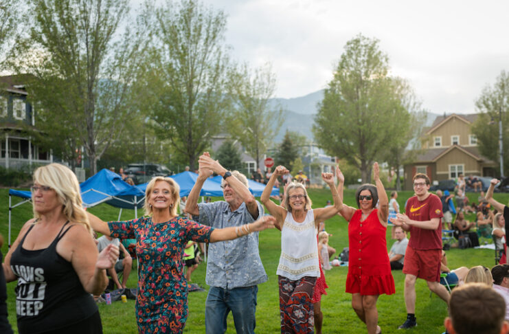 Neighbors dance in a line at Music on the Mesa at Gold Hill Mesa in Colorado Springs