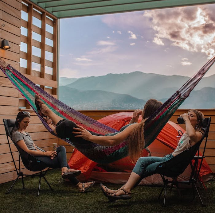 Hanging in hammocks on the rooftop camping deck at Kinship Landing hotel in Colorado Springs.