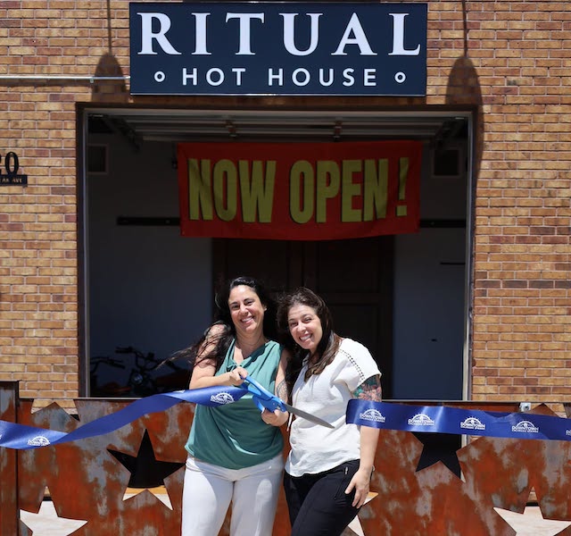 Owners cut the ribbon at the grand opening of Ritual Hot House.