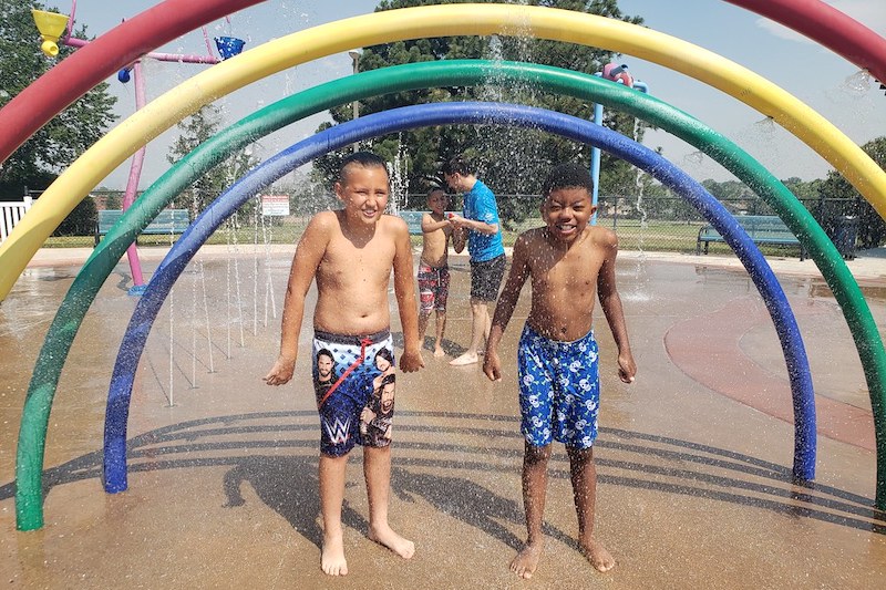 Two boys splash in the Deerfield Hills Spray Ground in Colorado Springs.