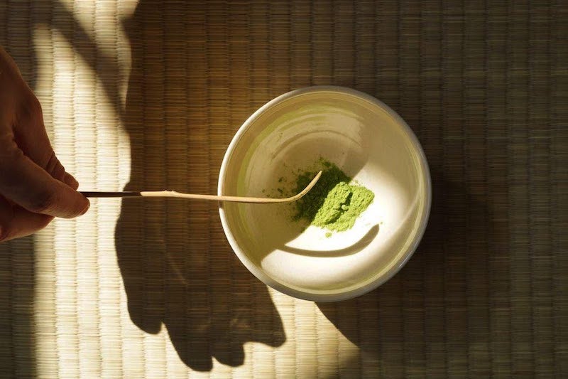 Stirring matcha powder into a mug at BrewCHA Tea Lounge in downtown Colorado Springs.