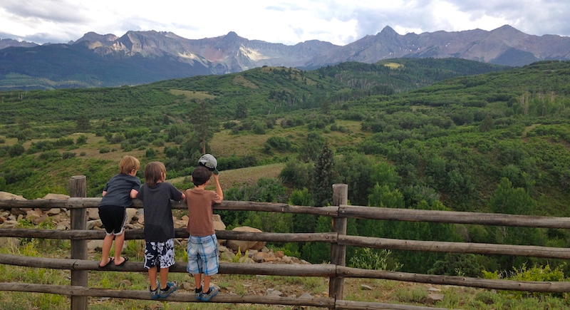 Three boys admire the view on Dallas Divide in Colorado.