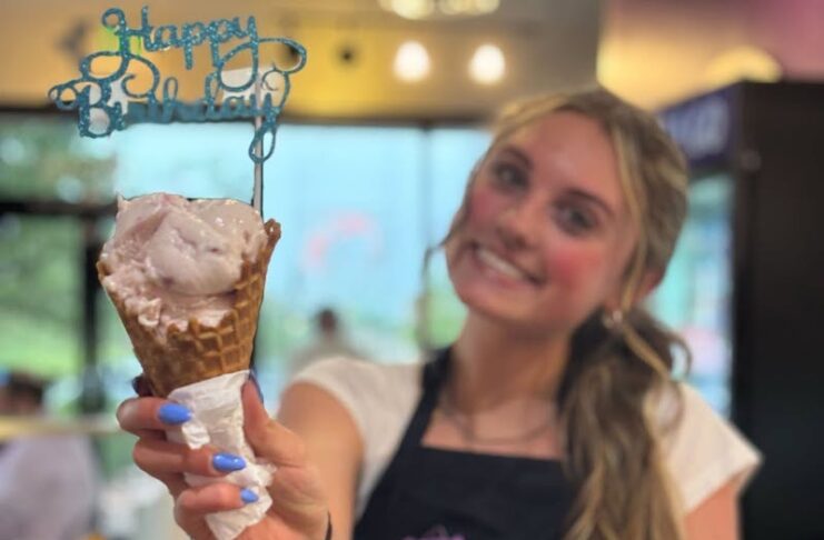 A worker holds up a Happy Birthday cone at Josh and John's, winner of our People's Choice Best Ice Cream in Colorado Springs.
