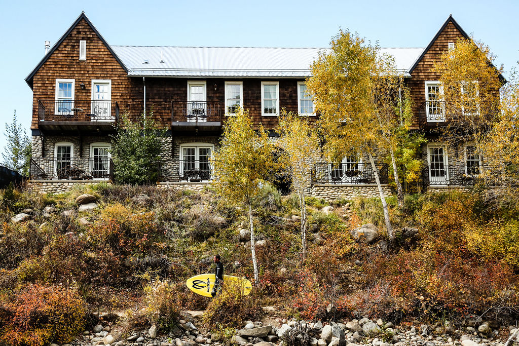 A surfer walks in front of the River Chateau at the Surf Hotel in Buena Vista, CO