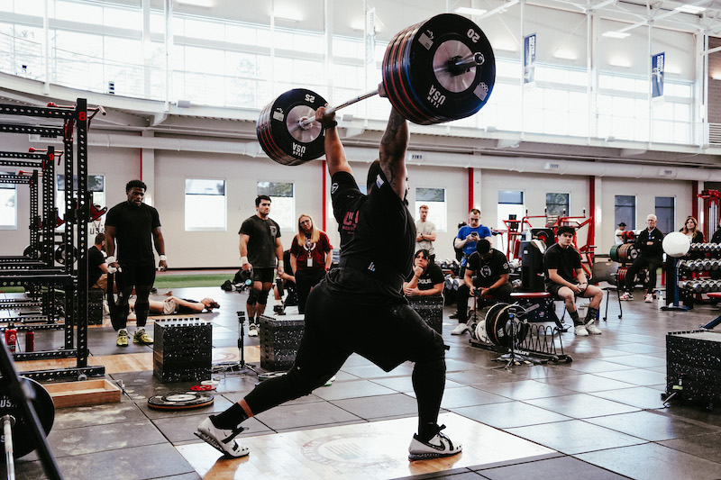 Team USA weightlifter Aaron Williams holds big weight overhead in a clean and jerk. 