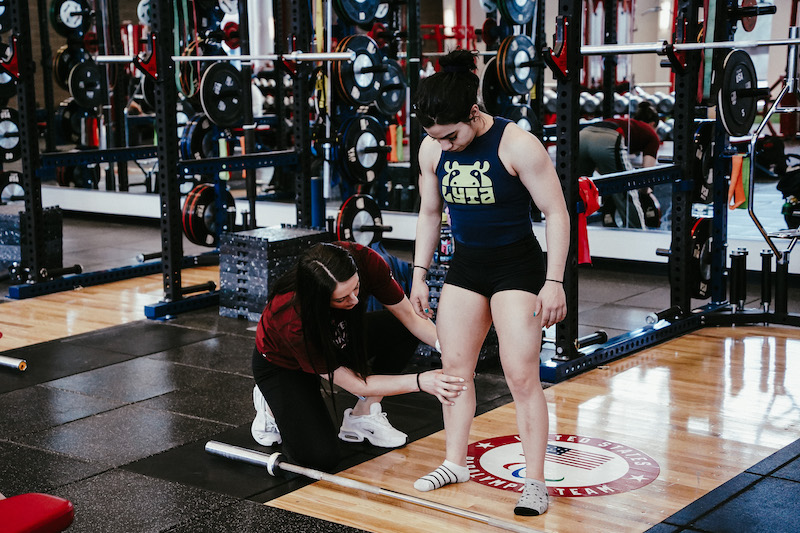 A trainer works with Diana “D” Irizarry at the U.S. Olympic and Paralympic Training Center. 