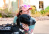 Police Foundation and Gold Hill Mesa Unveil 2027 CSPD K9 Calendar A woman hugs a CSPD K9 dog at Gold Hill Mesa during the launch event for the 2027 CSPD K9 Calendar.