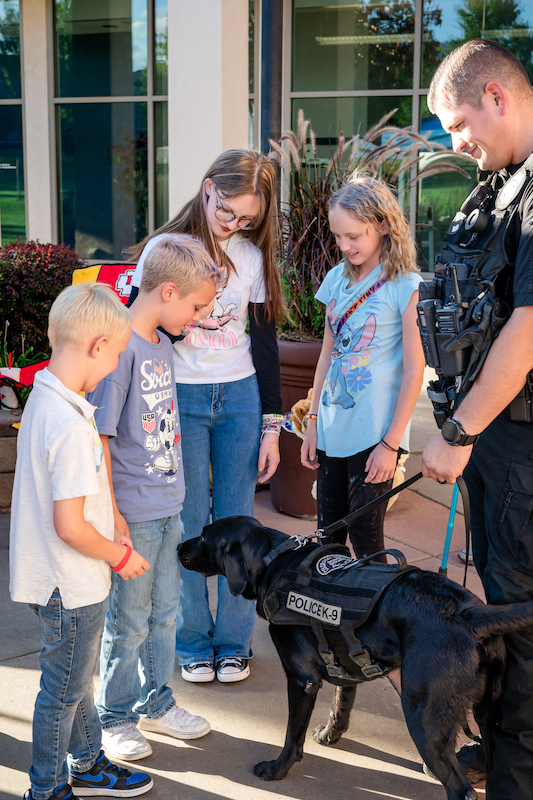 Kids meeting a CSPD K9 dog at Gold Hill Mesa.