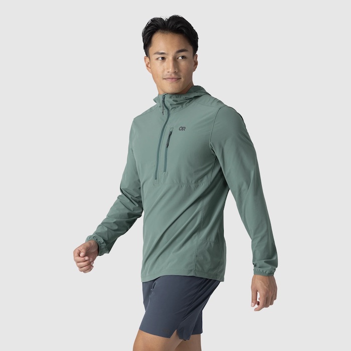 A man wears an Outdoor Research Astroman Sun Hoodie.