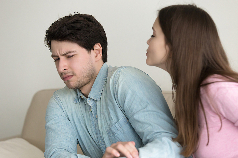 Woman coming on too strong on a first date. He's rejecting the kiss.